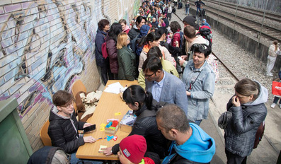 People queue for registration at a distribution depot of Swiss aid